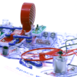 A close-up view of a Snap Circuits kit consisting of electrical components likes, switch, lights, and batteries.
