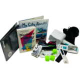 Three books, playing cards, dog stuffy, dice, and other components from the Vision Tech Kit.